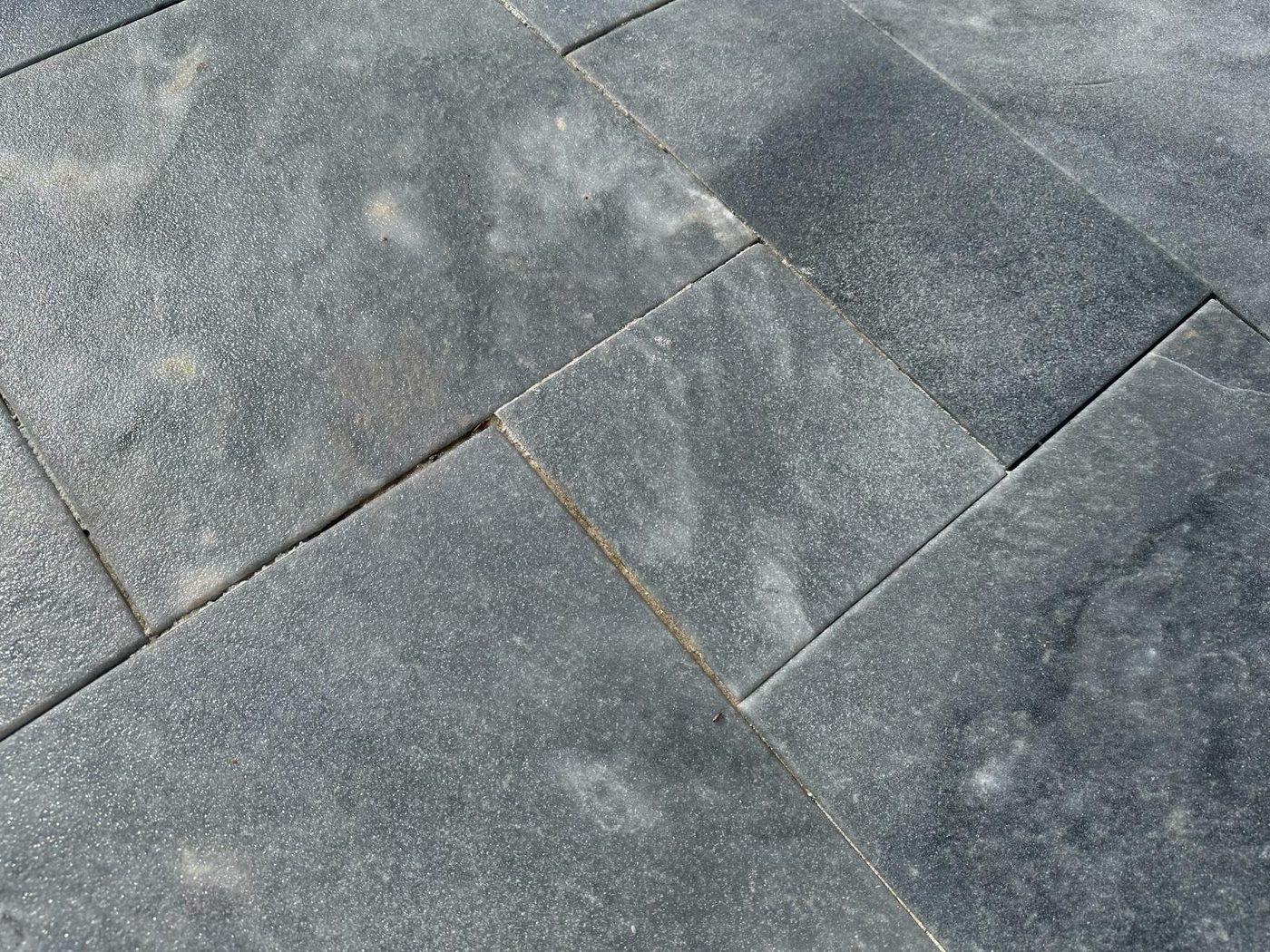 Iron stain emerging through joints between stone pavers